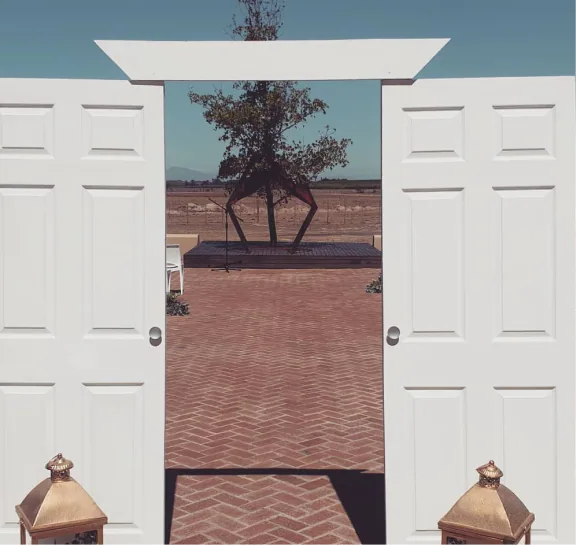 White event entrance doors opening onto a courtyard